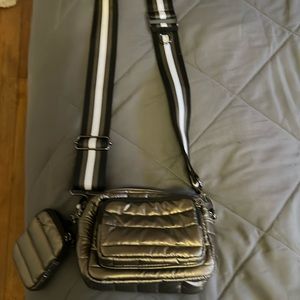 Think Rolyln Metallic Brinze crossbody bag with AirPod case attached